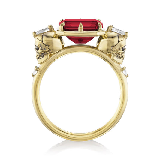 ::color_yellow ::|3.4ctw emerald cut lab-grown ruby engagement ring Juliet Skull memento mori yellow gold diamond accents standing side view