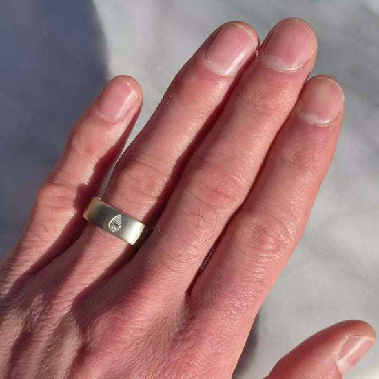 wide wedding band with pear diamond white gold video on hand
