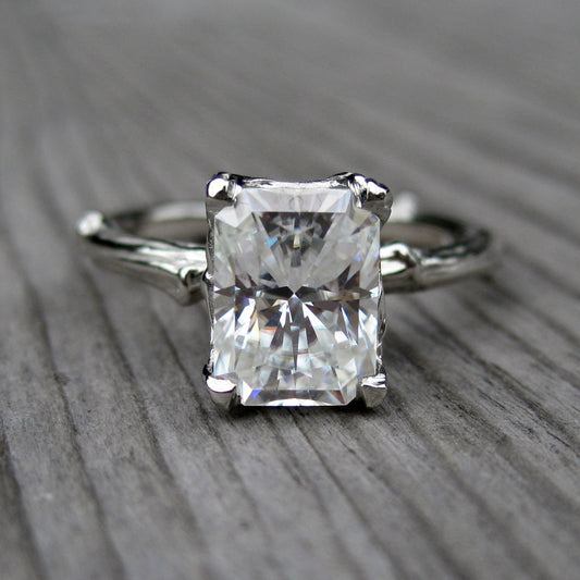 white gold twig solitaire engagement ring with a Forever One radiant cut moissanite