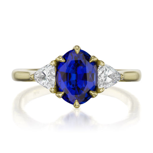 ::color_yellow ::| 2.17ctw oval blue sapphire three stone engagement ring Juno yelllow gold trillion diamonds front view