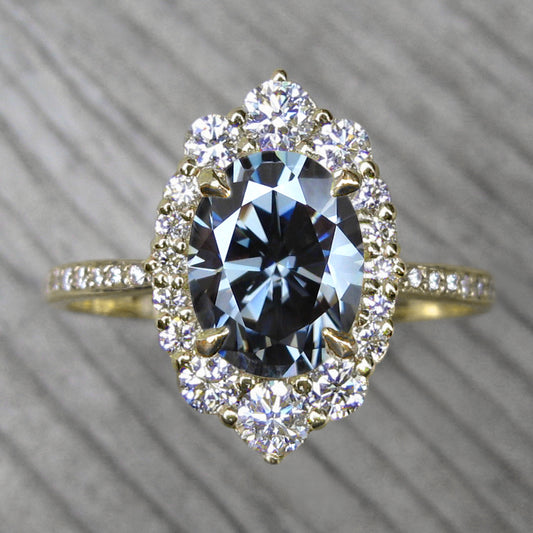 vintage inspired yellow gold halo with an oval grey moissanite