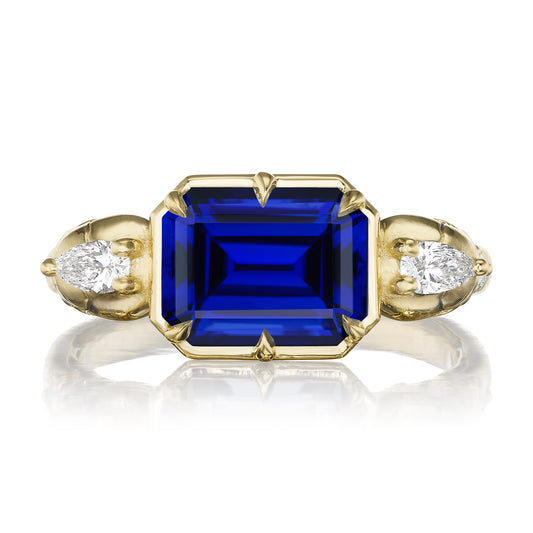::color_yellow ::|3.4ctw emerald cut lab-grown blue sapphire engagement ring Juliet Skull memento mori yellow gold diamond accents lay flat top view
