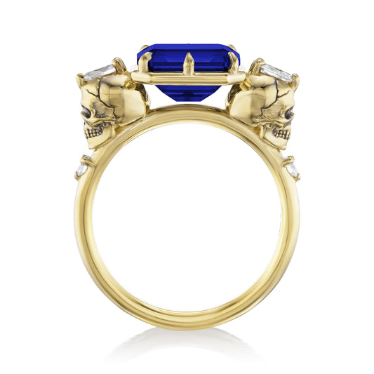 ::color_yellow ::|3.4ctw emerald cut lab-grown blue sapphire engagement ring Juliet Skull memento mori yellow gold diamond accents standing front view