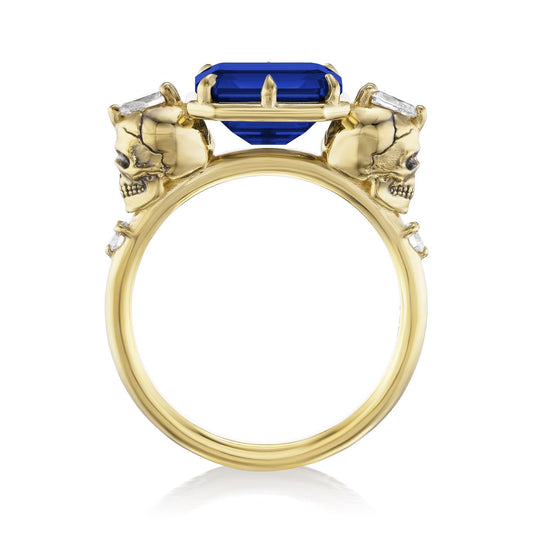 ::color_yellow ::|3.1ctw radiant cut lab-grown blue sapphire engagement ring Juliet Skull memento mori yellow gold diamond accents standing front view