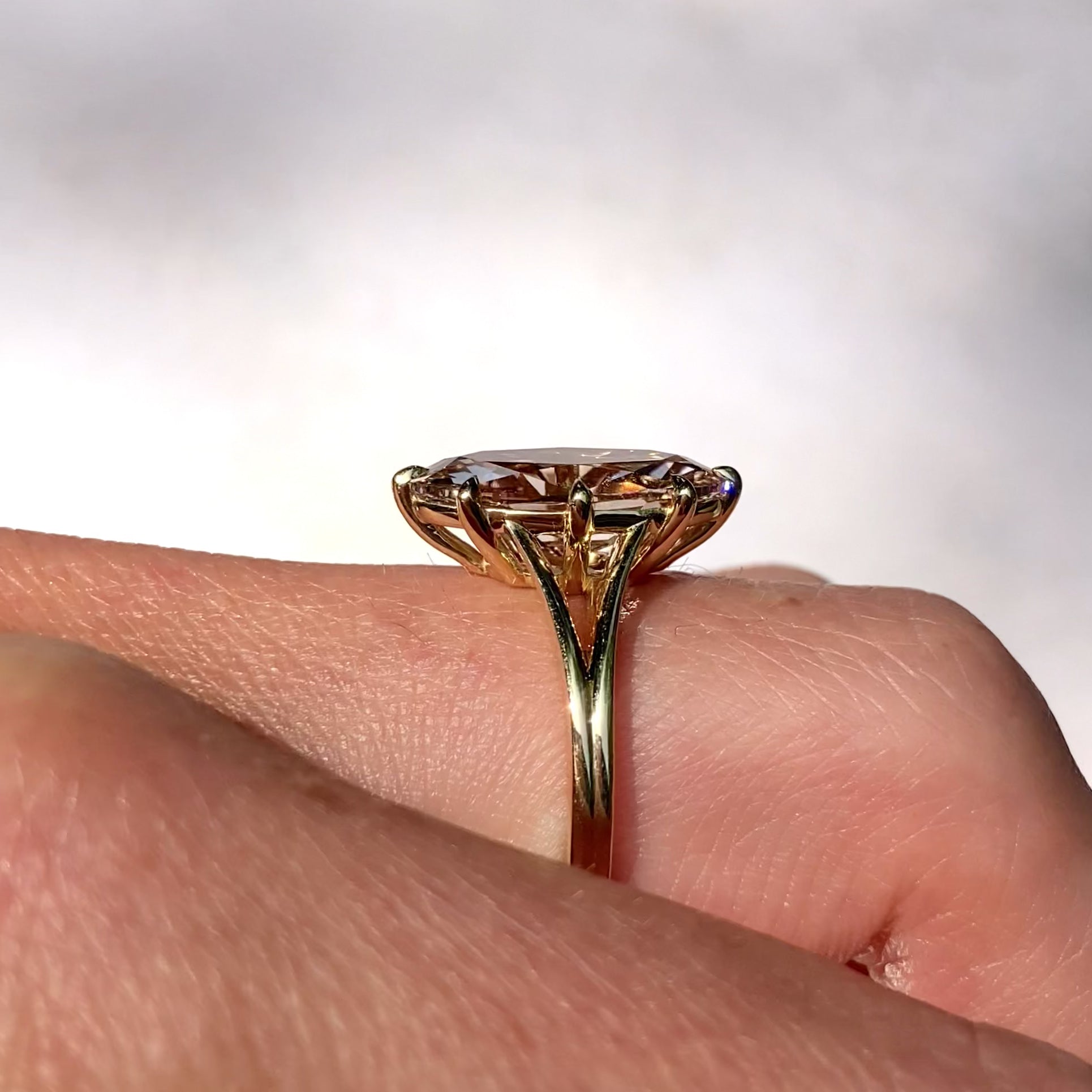 ::color_yellow ::| Ophelia 3.2ct moval oval lab-grown champagne diamond solitaire engagement ring with a split shank in yellow gold worn on finger video