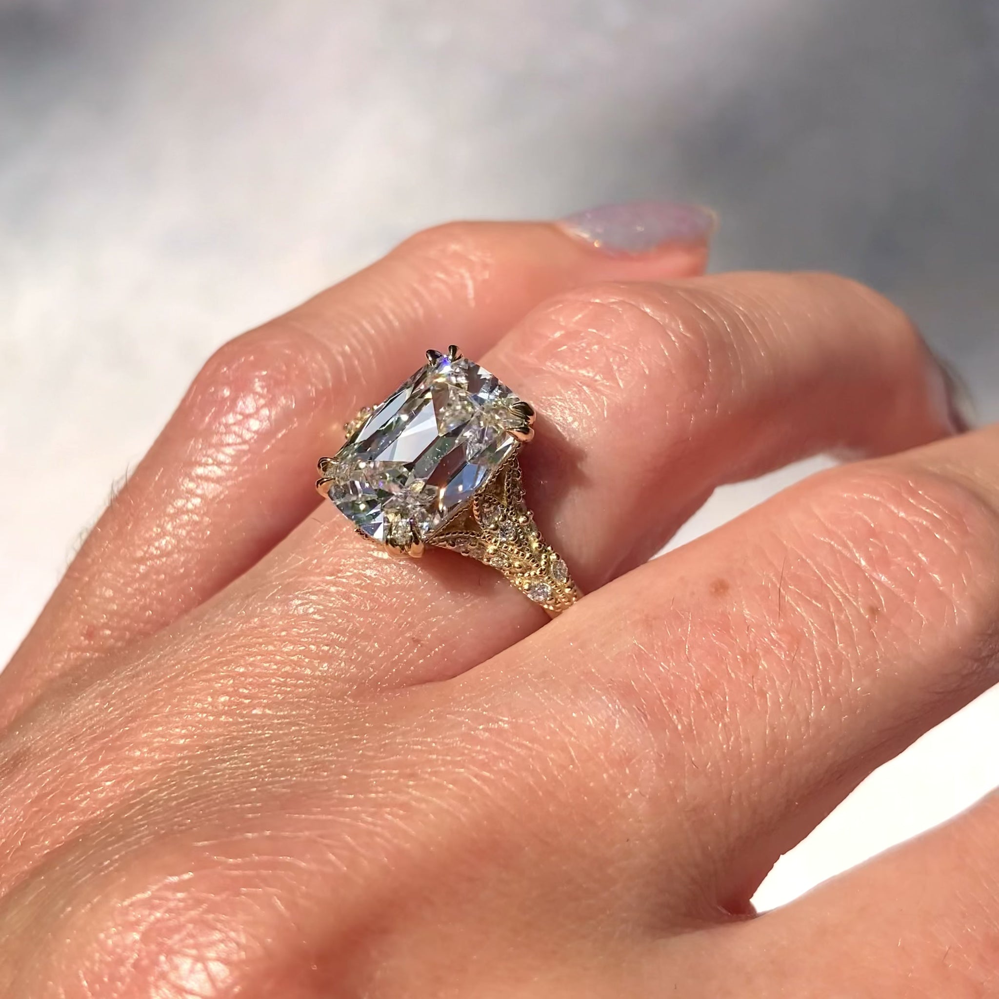 ::color_yellow ::| Florence Edwardian styled 4ct old mine cut lab-grown cushion diamond engagement ring with milgrain and diamond accents in yellow gold worn on finger video