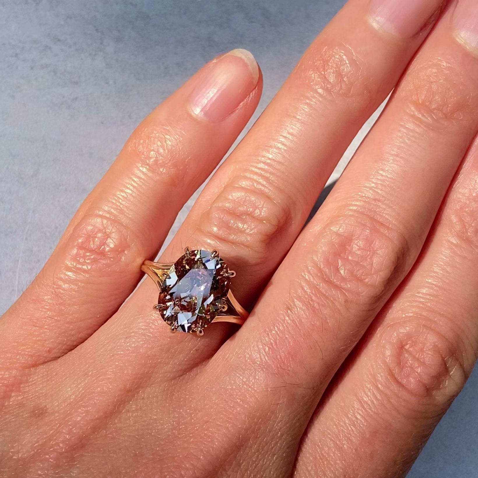 ::color_yellow ::| Ophelia 5ct Old Mine Cut cushion lab-grown champagne diamond solitaire engagement ring with a split shank in yellow gold modeled on finger video