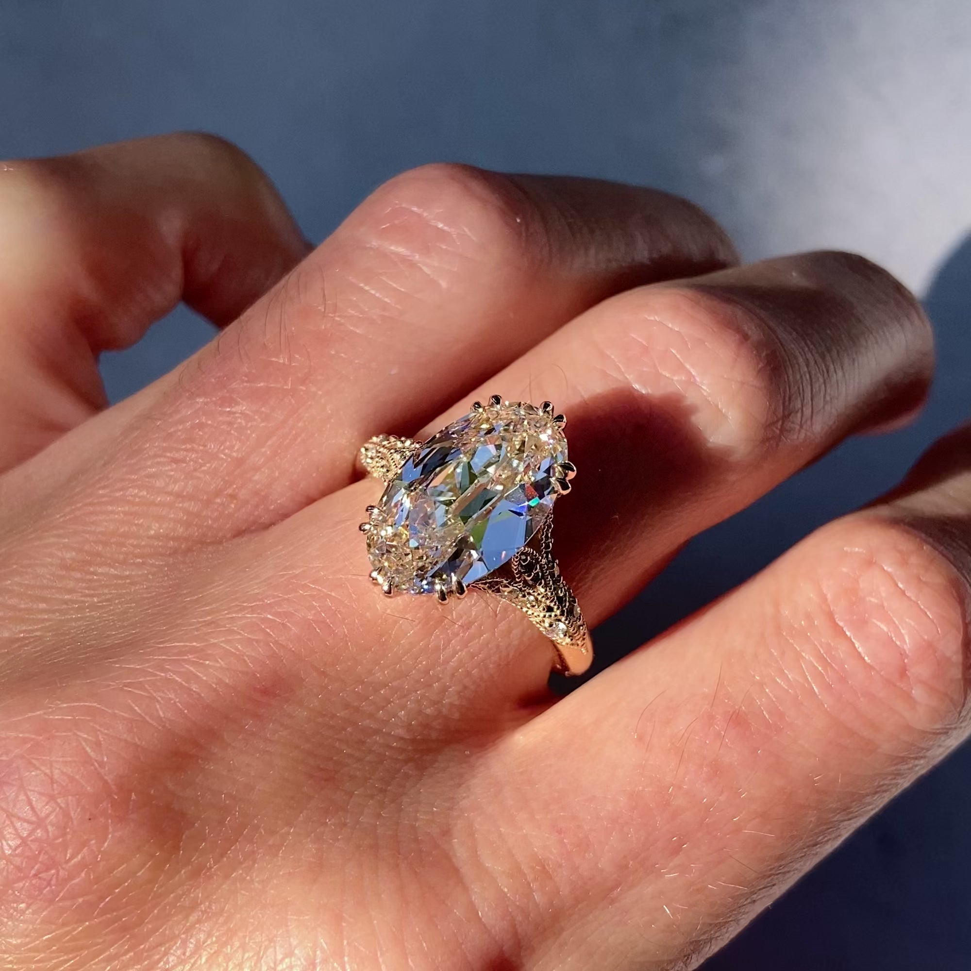 ::color_yellow ::| Florence Edwardian styled 4ct old mine cut lab-grown moval diamond engagement ring with milgrain and diamond accents in yellow gold video with ring modeled on finger