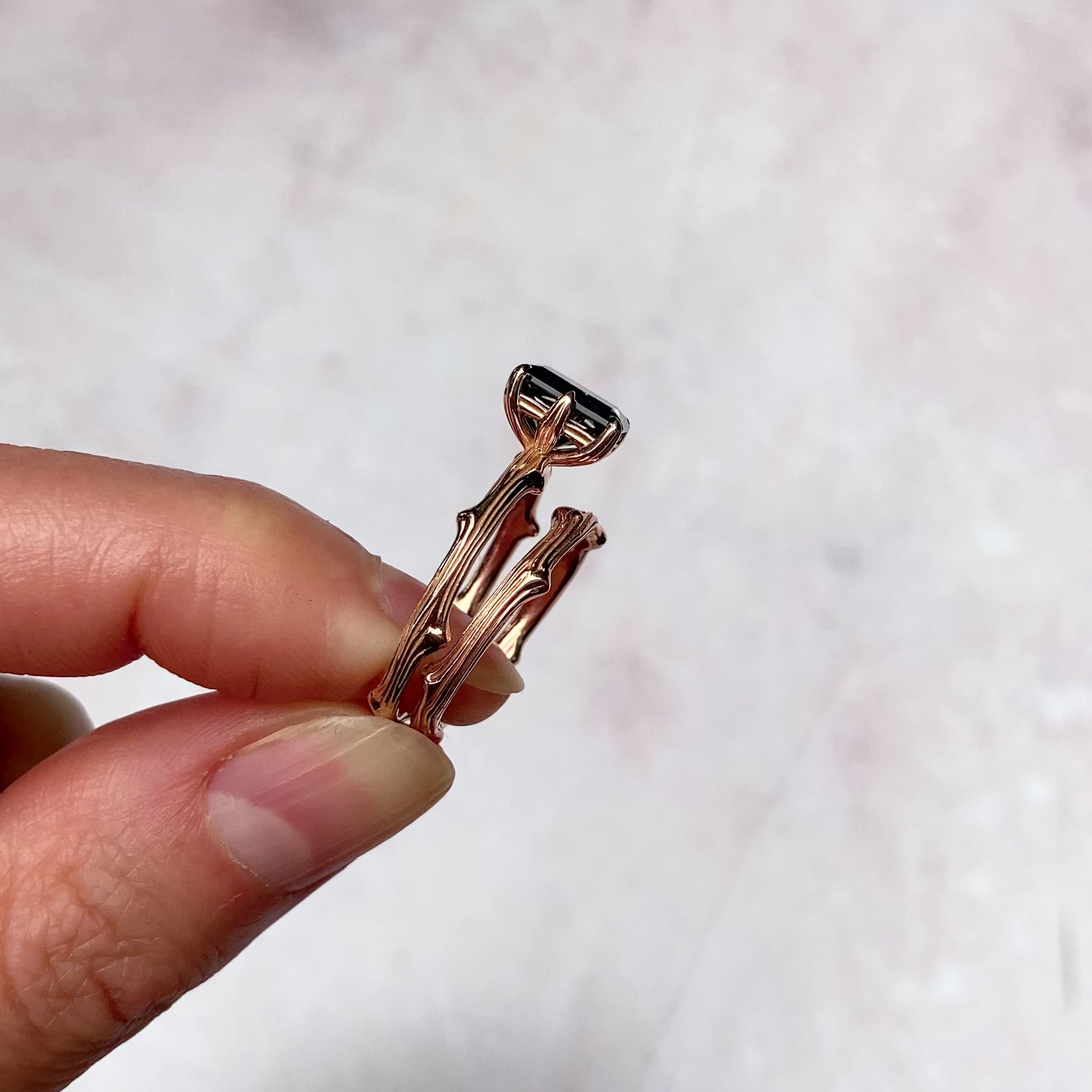 ::color_rose ::| 1.8ct radiant cut Iconic grey moissanite solitaire engagement ring with a twig band rose gold held in hand ring set video