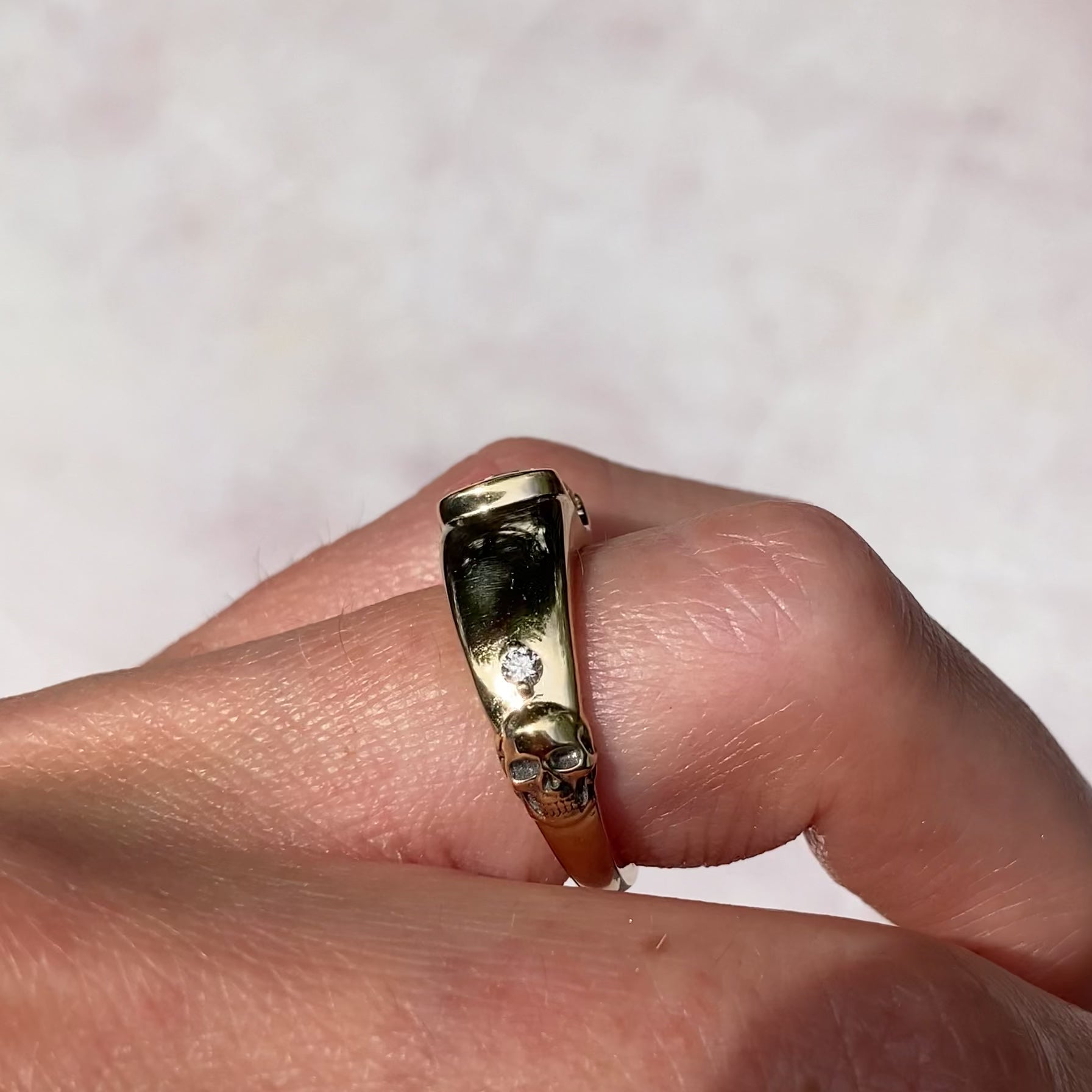 ::color_yellow ::| 2.16ct champagne Ashoka cut lab diamond ring with inspiration from antique memento mori jewelry. Sleek and minimalist from the top, but with a hidden surprise gold skull and accent diamond on one side yellow gold modeled on finger side view video