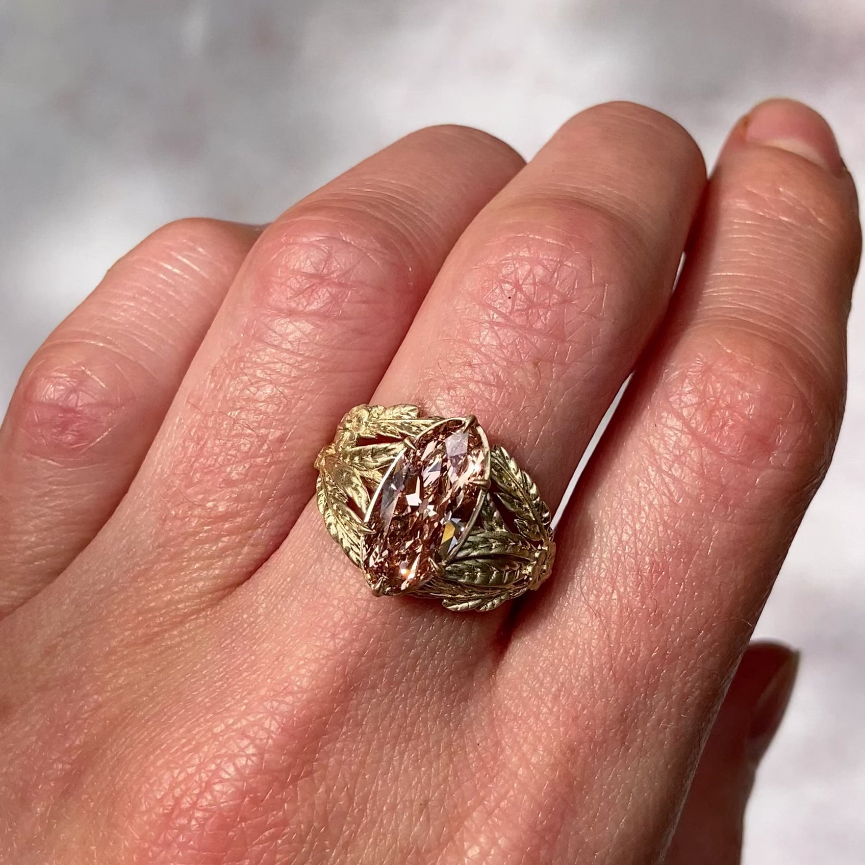 ::color_yellow ::| 3.05ct champagne moval lab diamond framed by a tangle of leaves, ferns, and forget me not flowers yellow gold warn on finger video