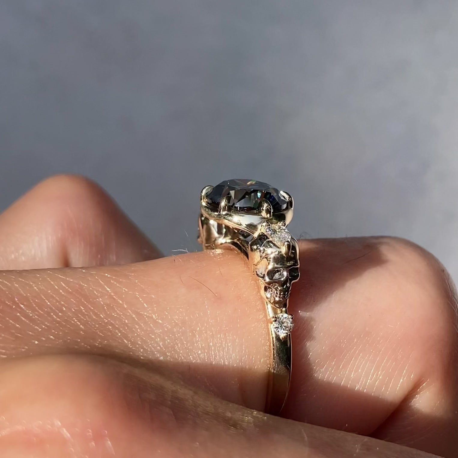 ::color_yellow ::| 2.65ctw oval grey moissanite engagement ring Juliet Skull memento mori yellow gold diamond accents video modeled on finger