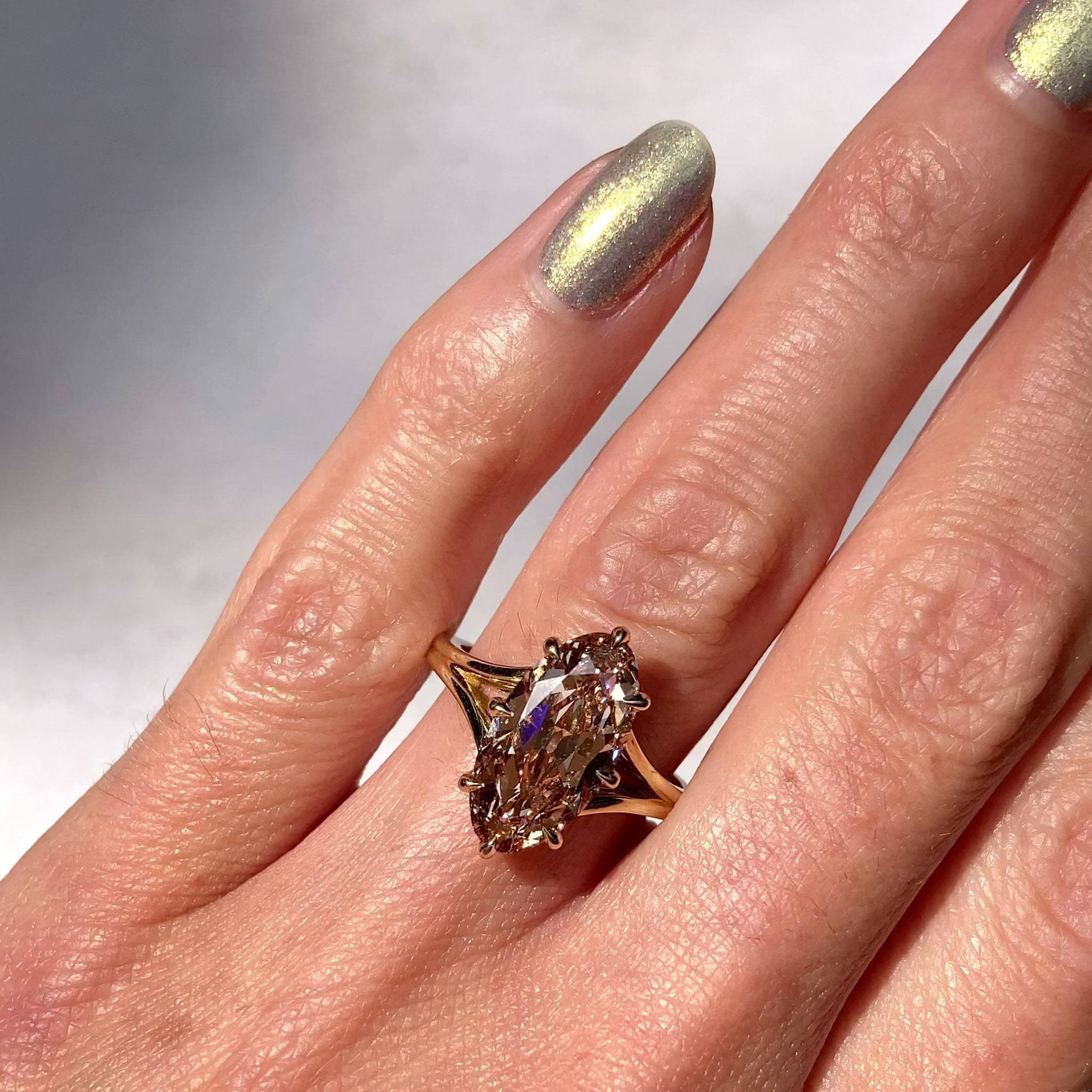 ::color_yellow ::| Ophelia 3.2ct moval oval lab-grown champagne diamond solitaire engagement ring with a split shank in yellow gold worn on finger video