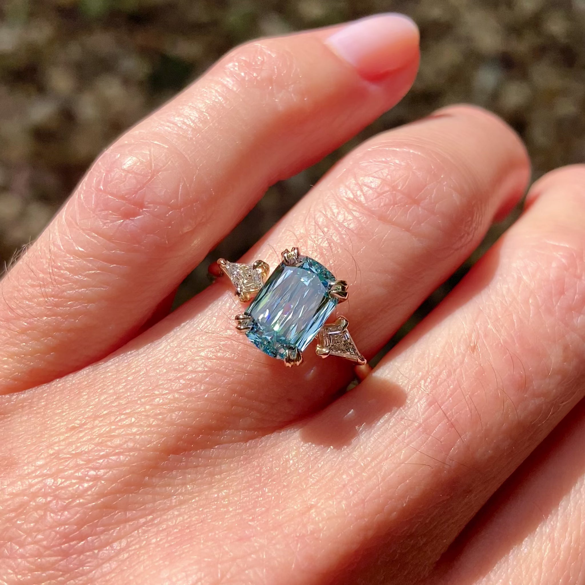 ::color_yellow ::| Raven 2ct scissor cut elongated cushion lab-grown blue diamond solitaire engagement ring with kite accent diamonds in yellow gold worn on finger video