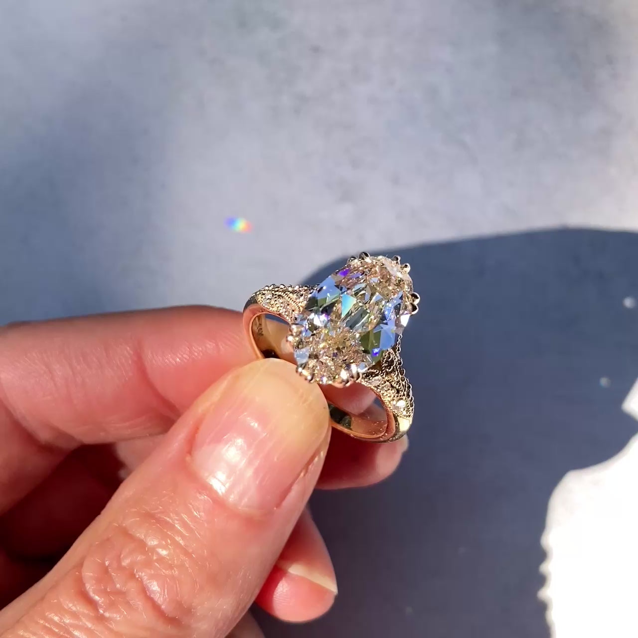 ::color_yellow ::| Florence Edwardian styled 4ct old mine cut lab-grown moval diamond engagement ring with milgrain and diamond accents in yellow gold video of the ring being held