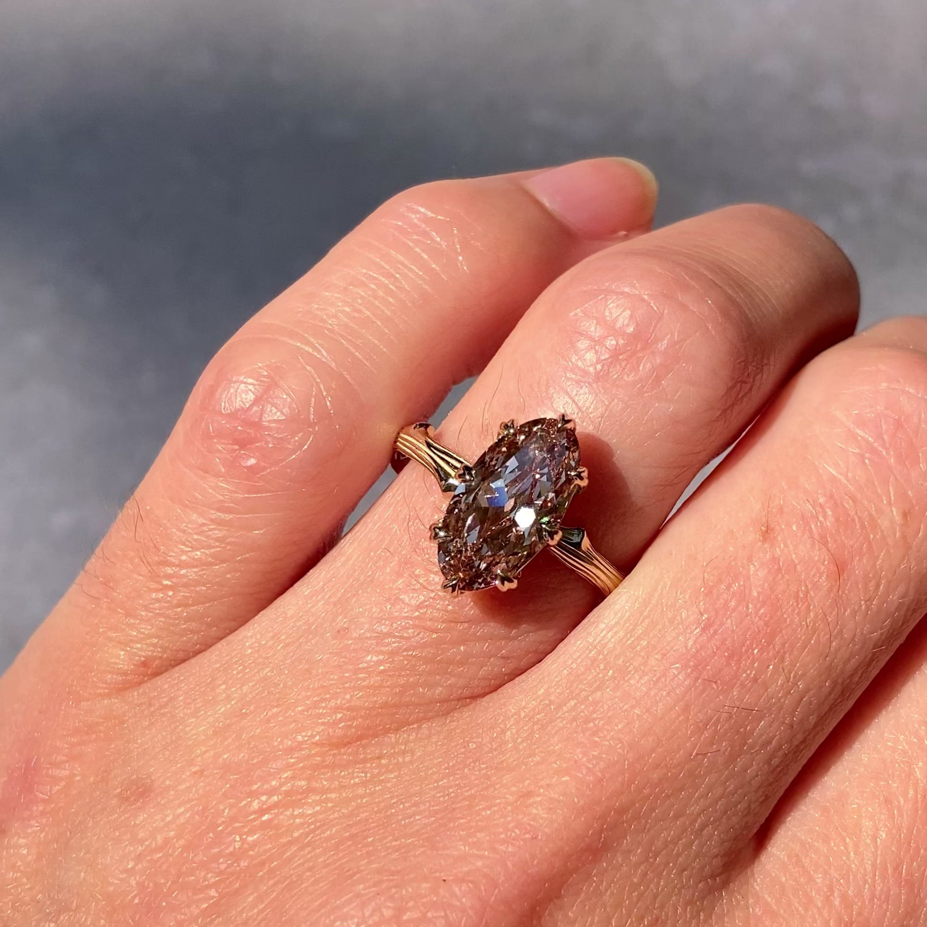 ::color_yellow ::| 2ct oval moval lab-grown diamond solitaire engagement ring with a twig band yellow gold worn on finger video