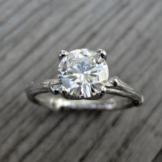 1ct white gold twig solitaire engagement ring with a Forever One Hearts & Arrows moissanite 