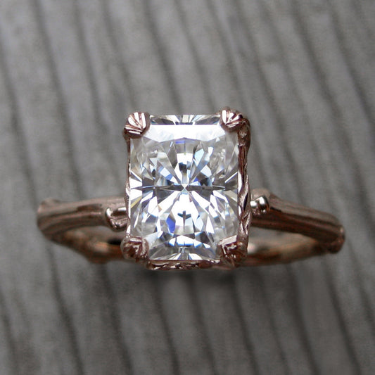 Rose gold twig solitaire engagement ring with a Forever One radiant cut moissanite 