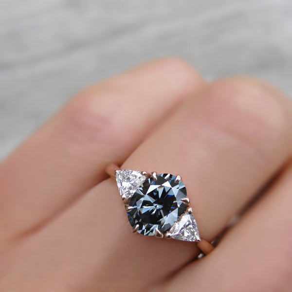 Oval engagement ring with online triangle side stones