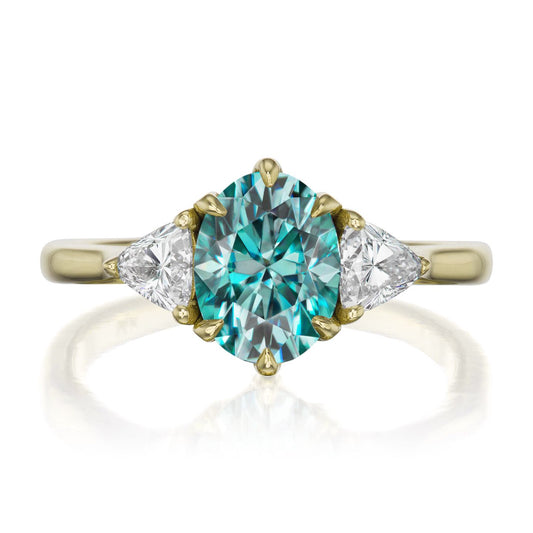 ::color_yellow ::| 1.92ctw oval aqua-teal moissanite three stone engagement ring Juno yellow gold trillion diamonds front view