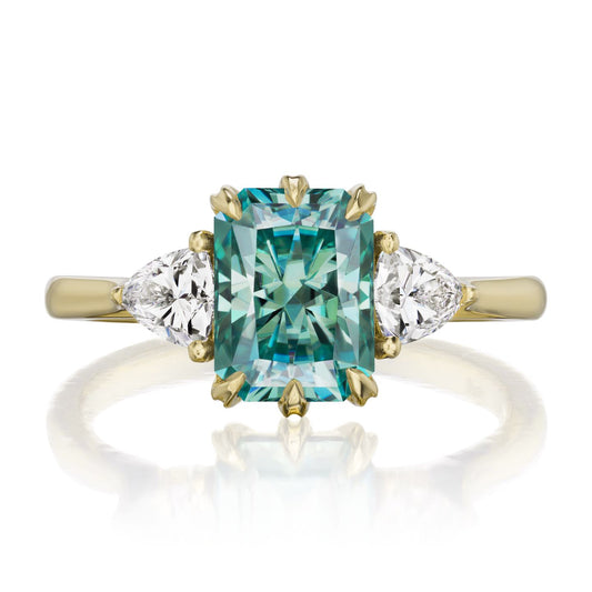::color_yellow ::| 2.22ctw radiant aqua-teal moissanite three stone engagement ring Avery yellow gold trillion diamonds front view